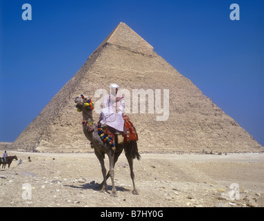 Egyptian character on camel beside the Great Pyramid on the Giza Plateau near Cairo Stock Photo