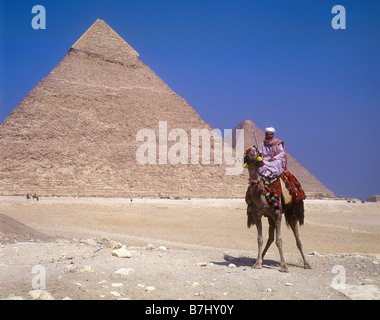 Egyptian character on camel beside the Great Pyramid on the Giza Plateau near Cairo Stock Photo