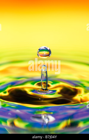 Rainbow coloured water drop and ripple Stock Photo