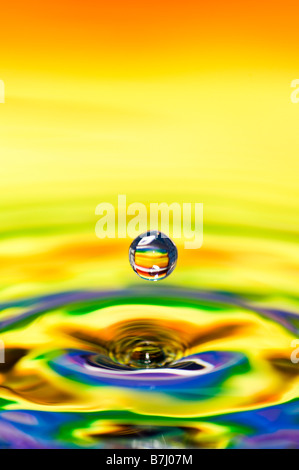 Rainbow coloured water drop and ripple Stock Photo