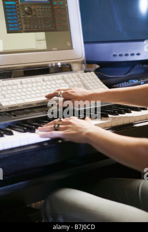 Caucasian woman in recording studio, B.C. Stock Photo
