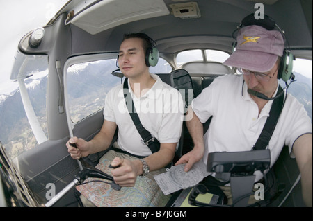 Pilots in a Cessna 172 In Flight, Vancouver, B.C. Stock Photo