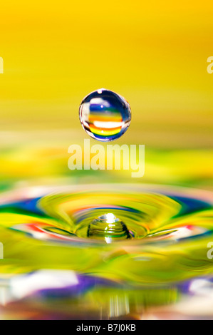 Rainbow coloured water drop and ripple Stock Photo