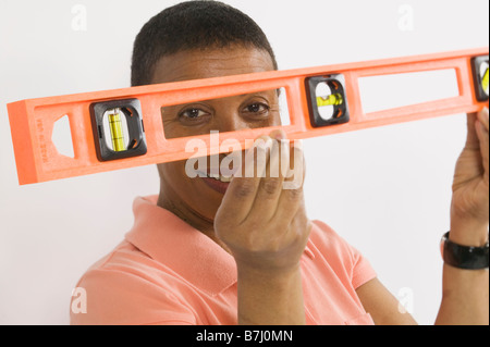 African American Woman Doing Home Improvement, Using a Spirit Level, B.C. Stock Photo