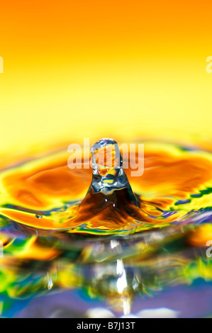 Rainbow coloured water drop and ripple Stock Photo