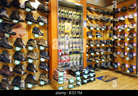 A display wall of different climbing boots and socks for sale in a specialist shop Stock Photo