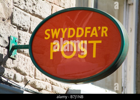 dh  SIGNPOST WALES Bilingual Post Office sign Welsh and English writing language signs two languages Stock Photo
