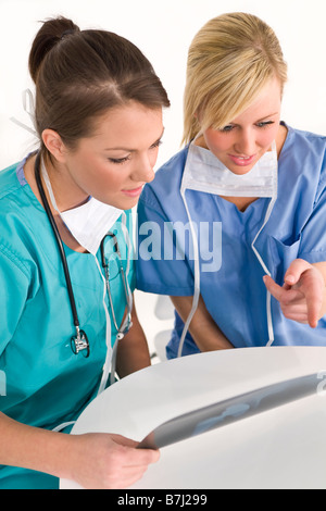 Two female doctors examining an X ray of a human hip Stock Photo