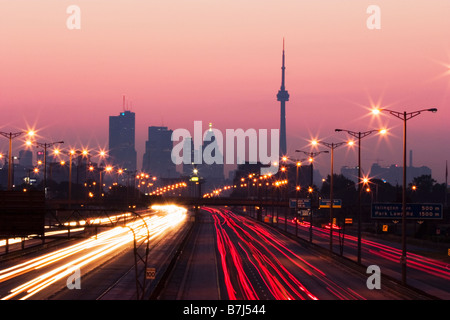 View of Toronto skyline from above Queen Elizabeth Way highway during start of rush hour traffic, Toronto, Ontario, Canada. Stock Photo