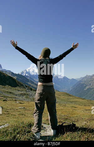 Young girl (19) arms stretched in front of Mont Blanc, Col de Balme Chamonix, France Stock Photo