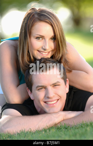 Boy and girl teenagers in grass at park, Regina, Saskatchewan Stock Photo