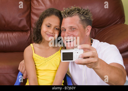 Caaucasian father taking picture of self and Mulatto daughter (6 years old) Stock Photo