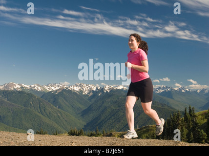 A woman trail running on Hurricane Ridge, Olympic National Park Stock Photo