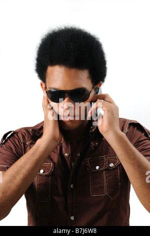 Portrait of young trendy african hispanic man using cell phone - isolated Stock Photo