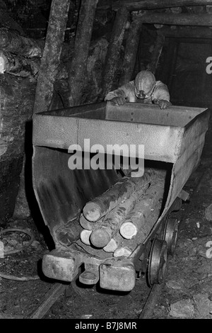 miners-pushing-tram-of-pit- miners-pushing-tram-of-pit-