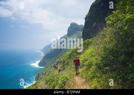 Hiker on the Kalalau Trail Na Pali Coast National Park Kaua i Hawaii USA Stock Photo