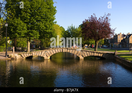Early morning on the River Windrush flowing through the Cotswold village of Bourton on the Water, Gloucestershire Stock Photo
