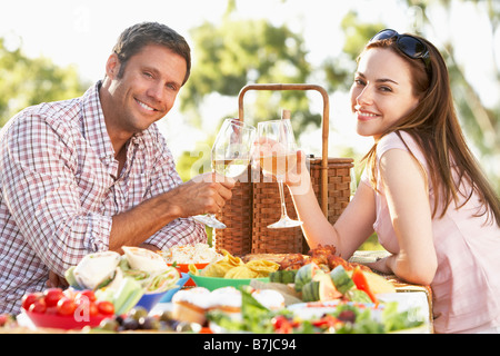 Couple Eating An Al Fresco Meal, Toasting With Wineglasses Stock Photo