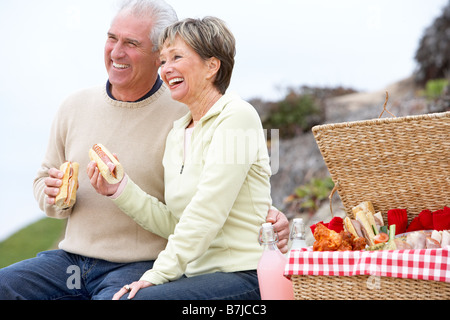 Couple Eating An Al Fresco Meal At The Beach Stock Photo