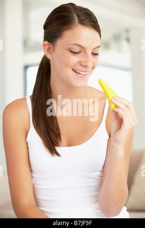 Young Woman Eating Fresh Pineapple Stock Photo