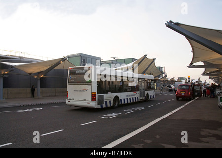 Heathrow Airport London England UK September The Departure building of Terminal 5 with an airport bus transporting passengers Stock Photo