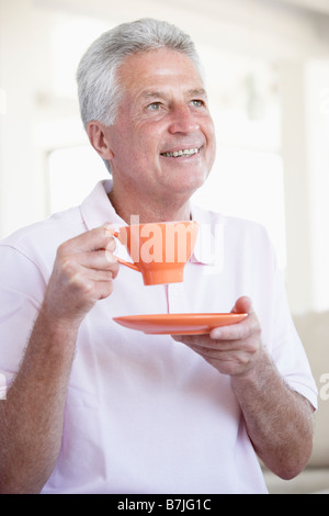Middle Aged Man Holding Orange Mug Stock Photo