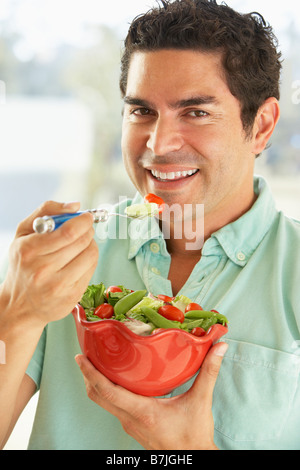 Mid Adult Man Holding A Bowl Of Salad, Smiling At The Camera Stock Photo