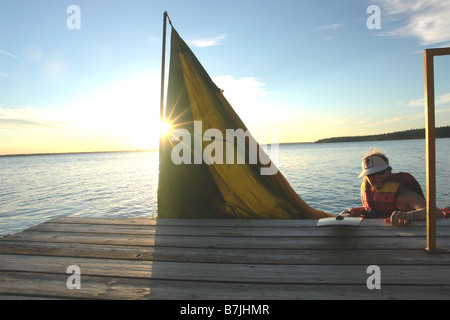 45 year old woman Kayaking on Clear Lake; Canada, Manitoba, Riding Mountain National Park Stock Photo