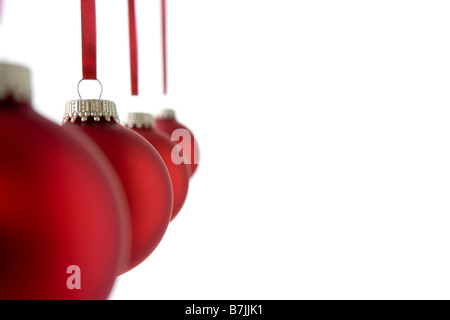 Line Of Red Christmas  Baubles Against White Background Stock Photo