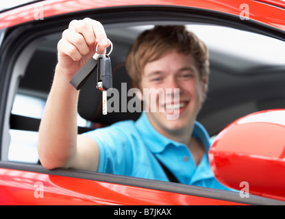 Teenage Boy Sitting In Car Holding Car Keys Stock Photo