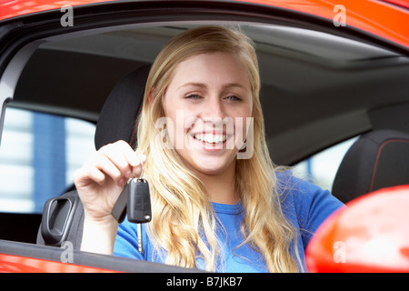 Teenage Girl Sitting In Car, Holding Car Keys And Smiling At The Camera Stock Photo