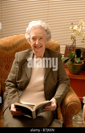 Senior Woman in Armchair; Canada, Saskatchewan, Regina Stock Photo