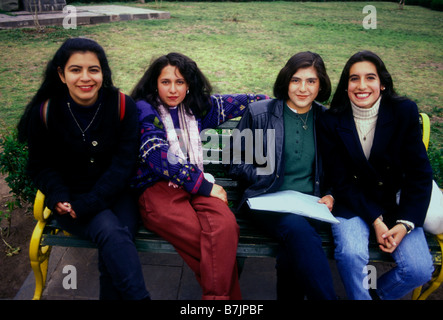 Peruvian women, young women, young adults, students, sitting on bench, Plaza de Armas, Cuzco, Cuzco Province, Peru, South America Stock Photo