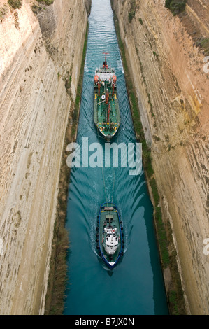 A tug pulls a fuel tanker through the Corinth Canal which jouns the gulf of Corinth with the Saronic Gulf Peloponnese Greece Stock Photo