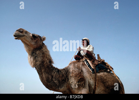 Saudi Arabia, Empty Quarter Rab al Khali Desert. Young al Murrah Bedu boy on camel Stock Photo