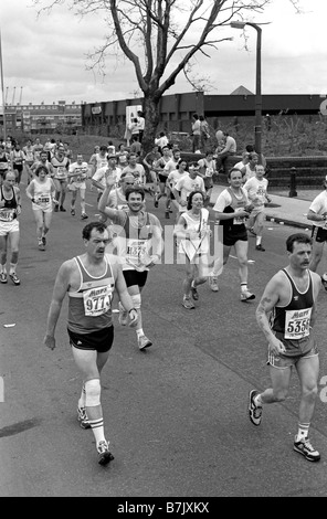 Runners in 1988 London Marathon with one waving and smiling. Stock Photo