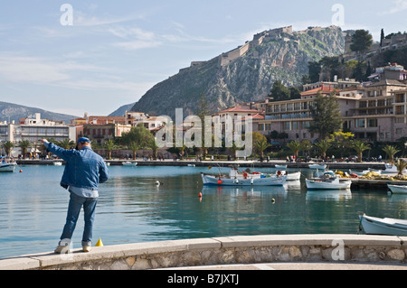 The harbour and waterfront at Nafplio with the Palamidhi fortress in the background Argolid Peloponnese Greece Stock Photo