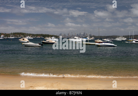 Fishing boats in Watsons Bay with the Sydney city skyline in the background Stock Photo