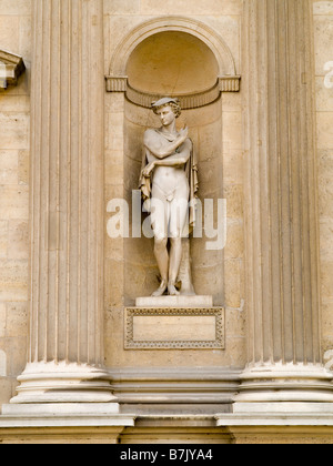 Close up of a stone statue in a recess of the Palais du Louvre (home of the Louvre Museum) in Paris, France Europe Stock Photo