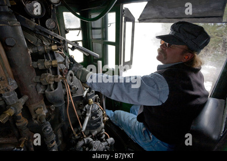 Engineer operates a steam powered locomotive on the Durango Silverton Narrow Gauge Railroad, southwestern Colorado