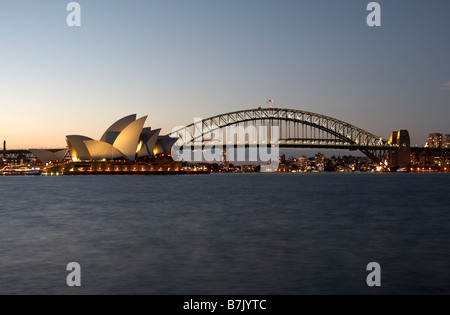 The Sydney Opera House and Sydney Harbour Bridge lit up at night taken from Mrs Macquaries Point Stock Photo