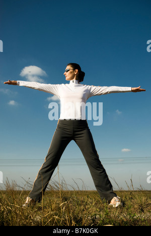 Female runner stretching in the Everglades, lifestyle portrait. Stock Photo
