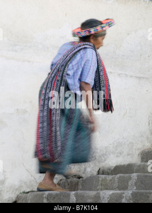 Villagers walking up church stairs Stock Photo