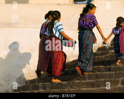 Villagers walking up church stairs Stock Photo