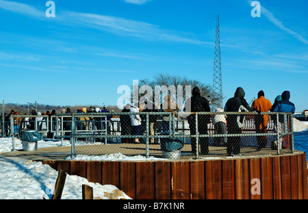 Photographers stand on one of the walkways overlooking the Mississippi river at Lock and Dam 14. Stock Photo