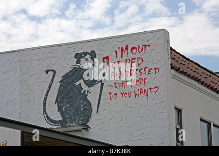 Banksy rat stencil asking I'M OUT OF BED, WHAT MORE DO YOU WANT? in Los Angeles Stock Photo