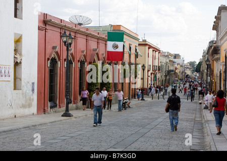 Oaxaca, Mexico. Street Scene, Mexican Flag, Calle Alcalá, Looking toward the Zócalo (Town Plaza) in the distance. Stock Photo