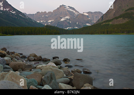 This is an early morning photo taken in July 2008 from the shoreline of Swiftcurrent Lake in Glacier National Park. Stock Photo