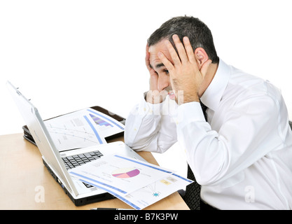Stressed businessman sitting at his desk isolated on white background Stock Photo