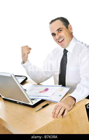 Happy smiling businessman sitting at his desk isolated on white background Stock Photo